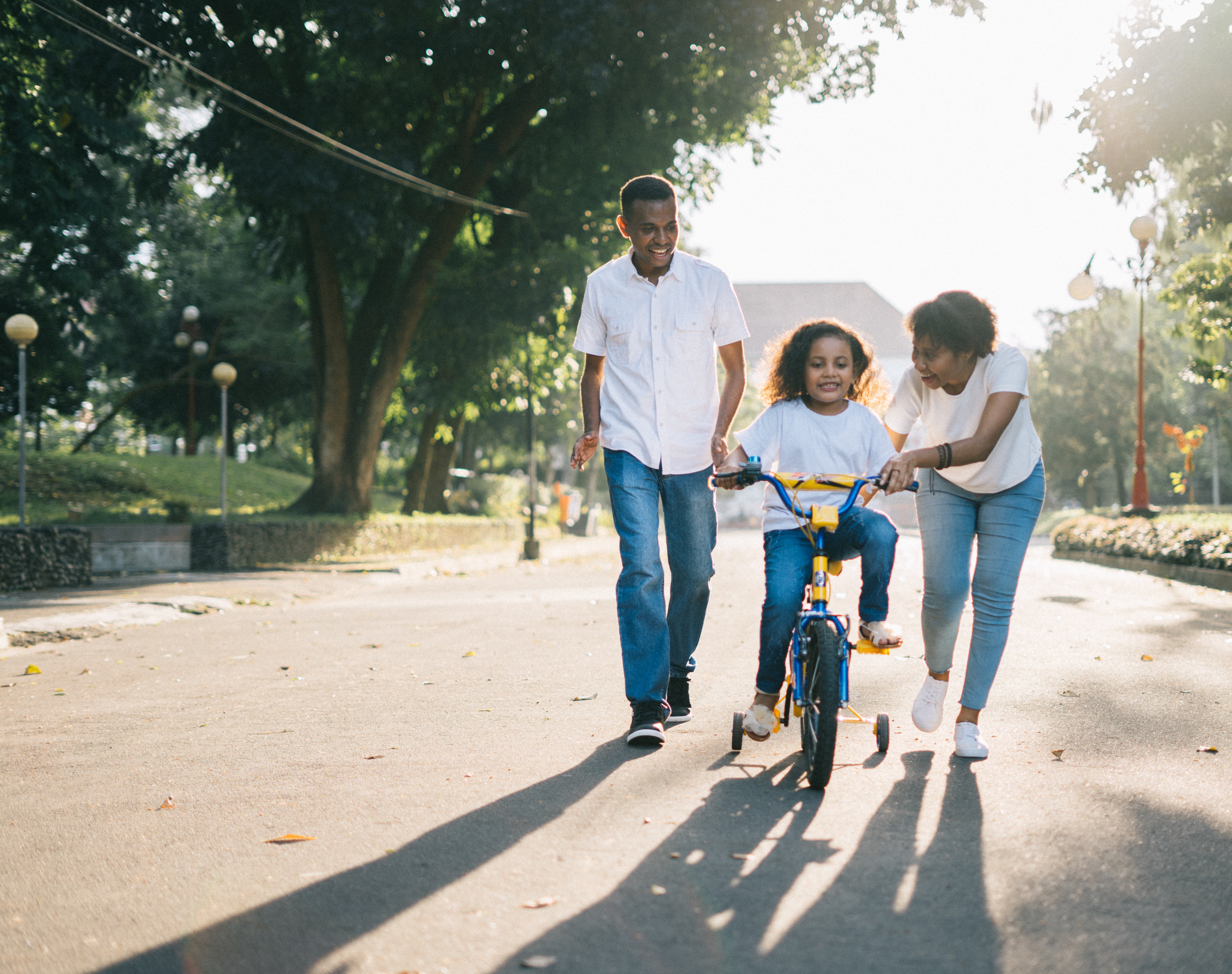 man standing beside his wife teaching their child how to 1128318