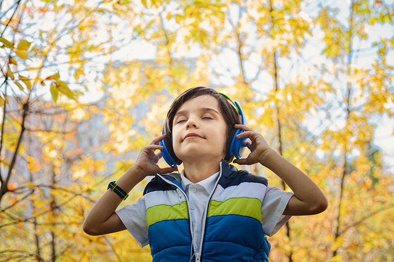 photo of a boy listening in headphones 1490844